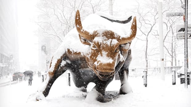 Charging bull in snow Wall Street