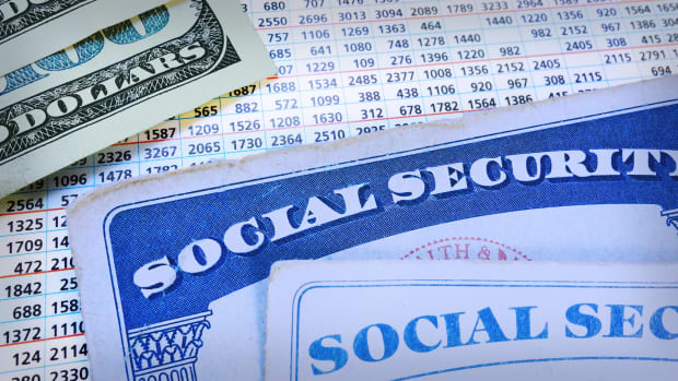 Social Security cards are seen with $100 bills. -lead