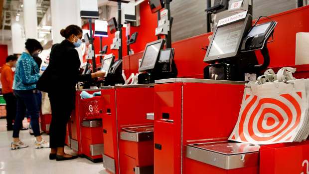 People use self checkout at a Target.