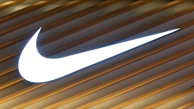 A Nike logo hangs on a wall outside a store in Toronto, Canada.