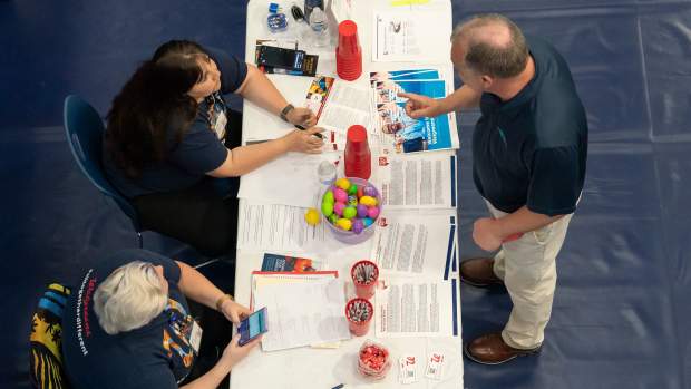 A jobseeker speaks with representatives at a job fair at Brunswick Community College in Bolivia, North Carolina, US, on Thursday, April 11, 2024. The Department of Labor is scheduled to release initial jobless claims figures on April 18. Photographer: Allison Joyce/Bloomberg via Getty Images