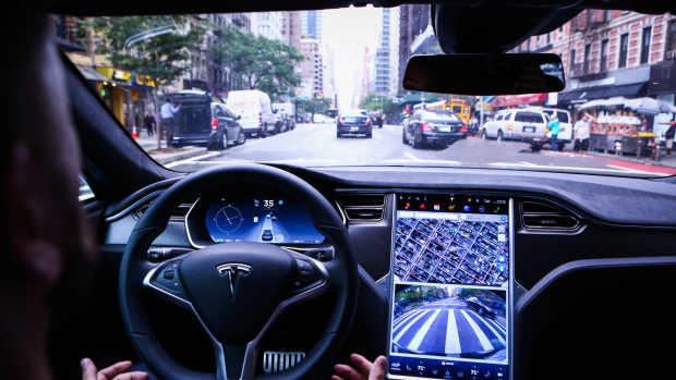 A driver rides hands-free in a Tesla Motors Inc. Model S vehicle equipped with Autopilot hardware and software in New York, U.S. on Monday, Sept. 19, 2016. The latest overhaul of the car's operating system, known as Tesla 8.0, biggest change is how Autopilot shifts towards a heavier reliance on its radar than its camera to guide the car through traffic. Photographer: Christopher Goodney/Bloomberg via Getty Images