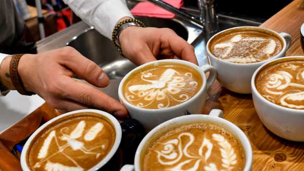 A barista performs latte art skills on a cappuccino during the 39th International trade Show of Artisan Gelato (ice cream), Pastry, Bakery and Coffe World (SIGEP) in Rimini, on January 21, 2018. / AFP PHOTO / Andreas SOLARO        (Photo credit should read ANDREAS SOLARO/AFP via Getty Images)