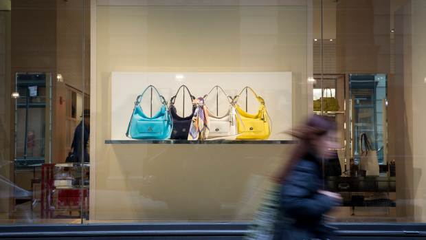 A pedestrian pass in front of Coach Inc. handbags displayed in the shop window at one of the company's locations in New York, U.S., on Tuesday, April 23, 2013. Coach Inc., the largest U.S. luxury handbag maker, reported fiscal third-quarter profit that beat analysts' estimates, helped by demand in North America, and said it may sell its Reed Krakoff brand. The shares jumped. Photographer: Scott Eells/Bloomberg via Getty Images