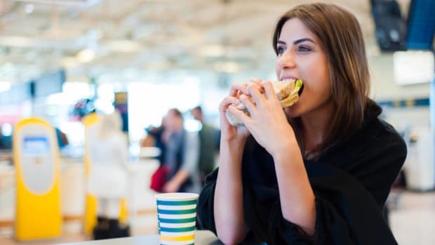 Woman eating a sandwich.