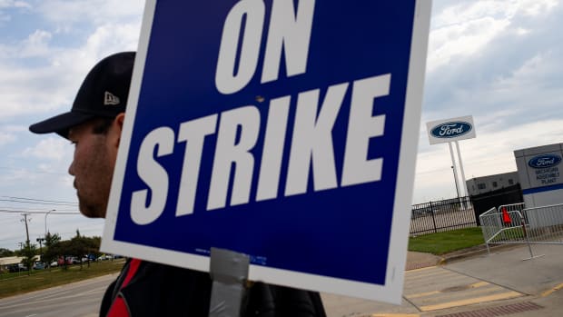 A "UAW On Strike" sign supporting United Auto Workers (UAW) members held on a picket line outside the Ford Motor Co. Michigan Assembly plant in Wayne, Michigan, US, on Wednesday, Sept. 20, 2023. The United Auto Workers said more of its members will go on strike at General Motors Co., Ford Motor Co. and Stellantis NV facilities starting at noon Friday unless substantial headway is made toward new labor contracts. Photographer: Emily Elconin/Bloomberg via Getty Images