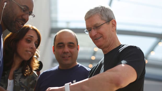 PALO ALTO, CA - APRIL 10: Apple CEO Tim Cook displays his personal Apple Watch to customers at an Apple Store on April 10, 2015 in Palo Alto, California. The pre-orders of the highly-anticipated wearable from the tech giant begins today as the watches arrive at stores for customers to preview.