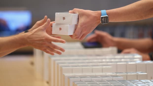 An Apple employee hands over Apple iPhone 7 phones on the first day of sales of the new phone at the Berlin Apple store on Sept. 16, 2016 in Berlin, Germany.   (Photo by Sean Gallup/Getty Images)