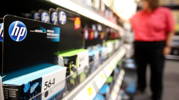 A Hewlett-Packard Co. printer ink cartridge is displayed for sale while a customer browses at a Best Buy Co. Inc. store in Orem, Utah, U.S., on Monday, May 16, 2011. Hewlett-Packard Co., the world's biggest personal-computer maker, cut a billion dollars from its sales forecast for the year and said profit is falling short as consumers hold back buying PCs. Photographer: George Frey/Bloomberg via Getty Images