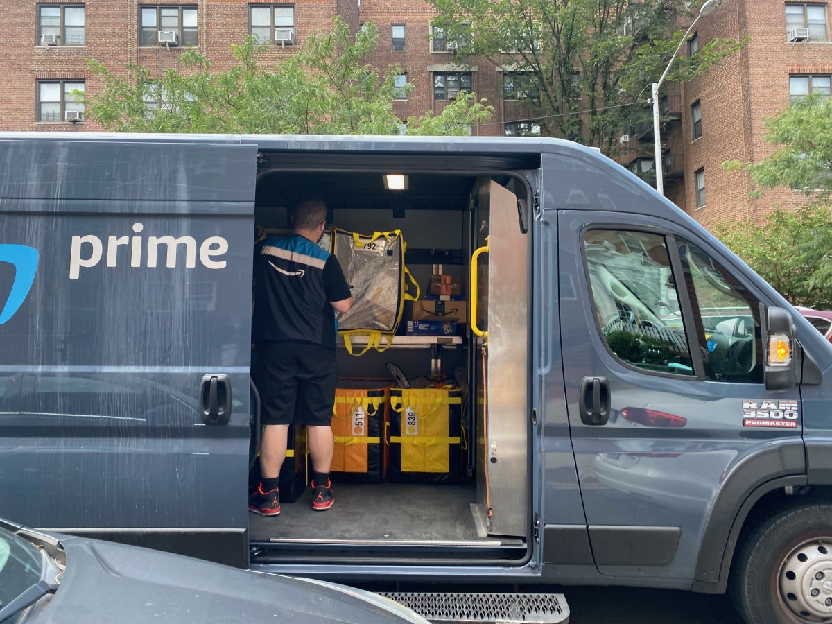 https://www.thestreet.com/.image/t_share/MjAxNDIwMTIzNTAyODE1MDY0/amazon-prime-delivery-person-in-van-sorting-packages-queens-new-york.jpg