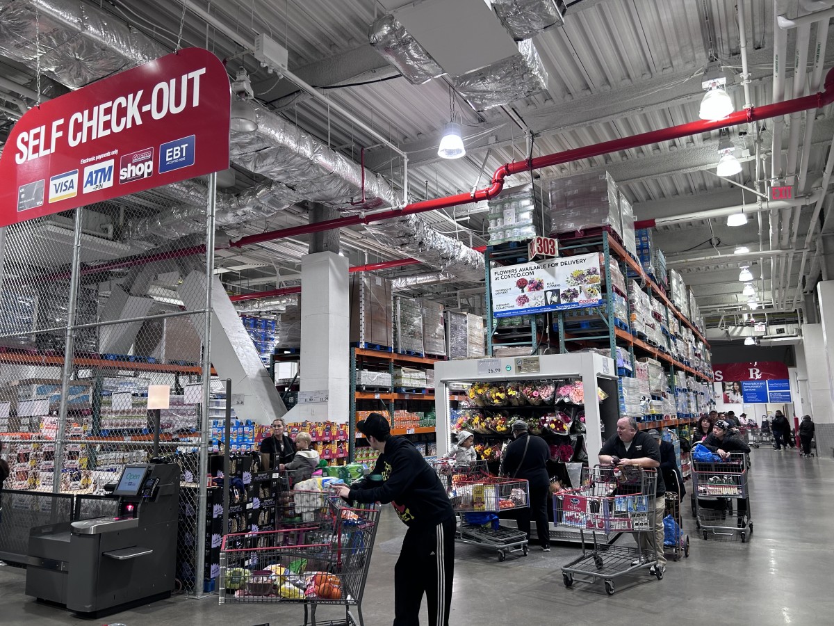 https://www.thestreet.com/.image/t_share/MjAyNzQzMDk5NTk0NjQ2NTQw/customers-using-costco-self-service-check-out-area-queens-new-york.jpg