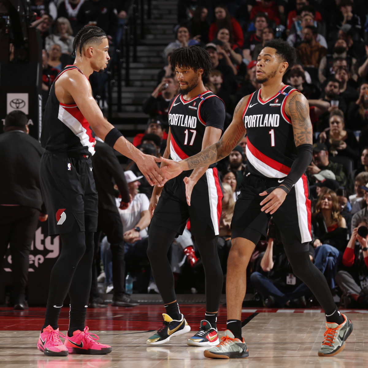 PORTLAND, OR - FEBRUARY 22:  Toumani Camara #33, Shaedon Sharpe #17 and Anfernee Simons #1 of the Portland Trail Blazers high five during the game against the Charlotte Hornets on February 22, 2025 at the Moda Center Arena in Portland, Oregon. NOTE TO USER: User expressly acknowledges and agrees that, by downloading and or using this photograph, user is consenting to the terms and conditions of the Getty Images License Agreement. Mandatory Copyright Notice: Copyright 2025 NBAE (Photo by Cameron Browne/NBAE via Getty Images)